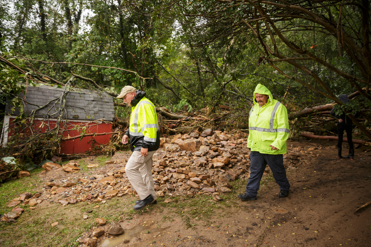 Soddy-Daisy Police Sgt. Mike Brown, left, and Fire Chief Mike Guffey survey damage behind a home one day after a deadly flash flood in the Depot Street area on Thursday, Sept. 27, 2018, in Soddy-Daisy, Tenn. Residents, volunteers and business owners returned Thursday following the flooding which killed one person Wednesday.