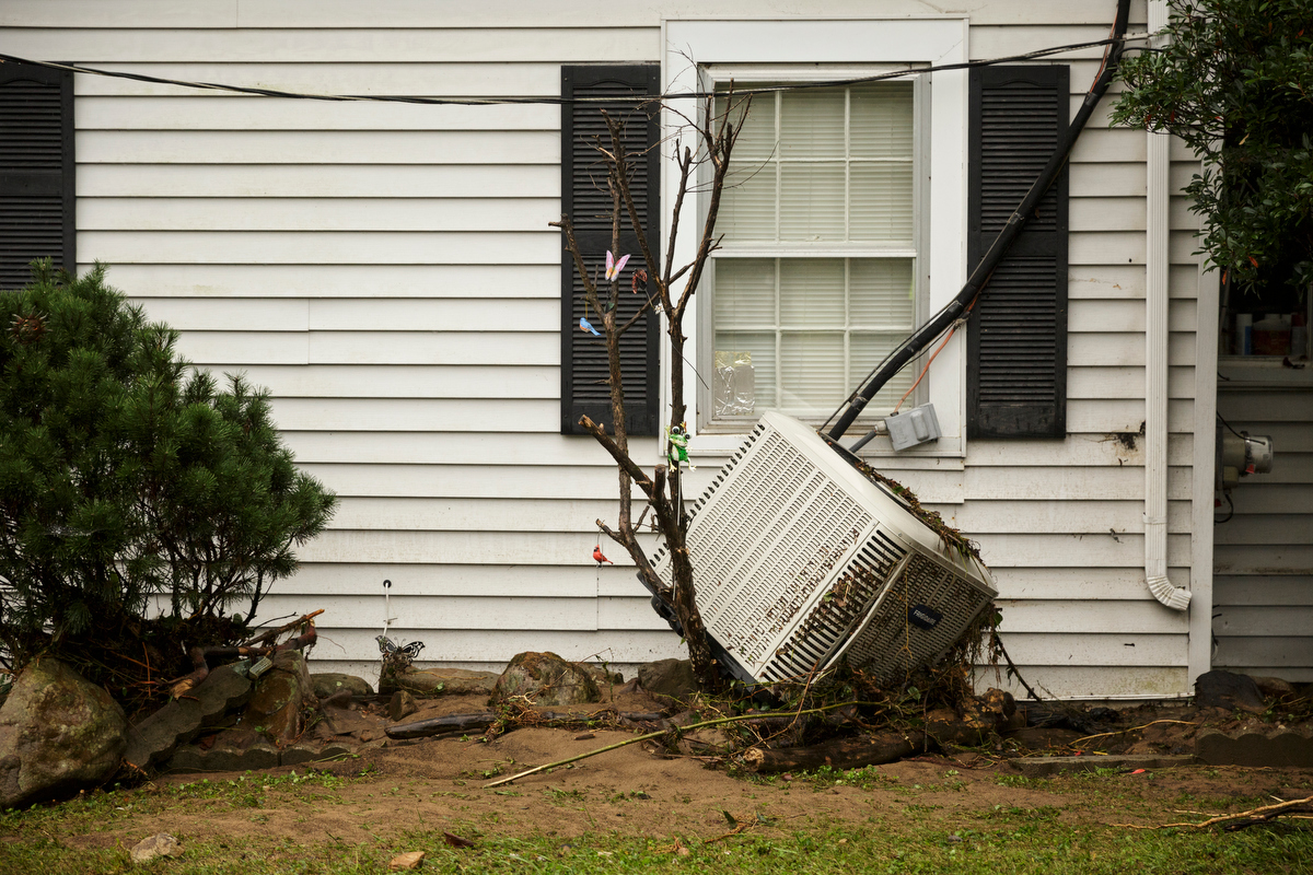 An air conditioner swept away by floodwaters rests against a tree one day after a deadly flash flood in the Depot Street area on Thursday, Sept. 27, 2018, in Soddy-Daisy, Tenn. Residents, volunteers and business owners returned Thursday following the flooding which killed one person Wednesday.