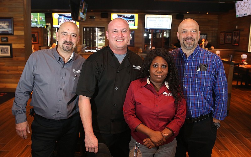 Staff photo by Erin O. Smith / Miller's Ale House managerial staff incudes Scott Blainey, Matt Fasbender, Aricka Johnson and T.J. Goodman. The restaurant is the first of three new Miller's Ale House restaurants that will be opening in Tennessee.