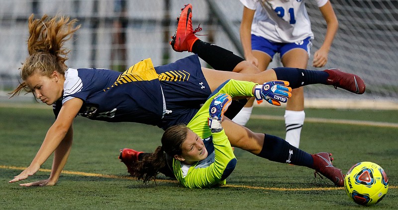 Chattanooga Christian's Kate Dirkse, top, gets tangled up with Boyd-Buchanan goalkeeper Kaitlyn Pope while competing for the ball Thursday night.