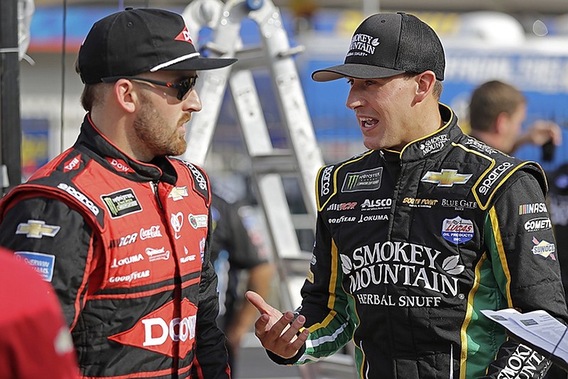 Austin Dillon, left, talks with Daniel Hemric before Friday's qualifying session at Charlotte Motor Speedway in Concord, N.C., for Sunday's race on the new "roval" course.