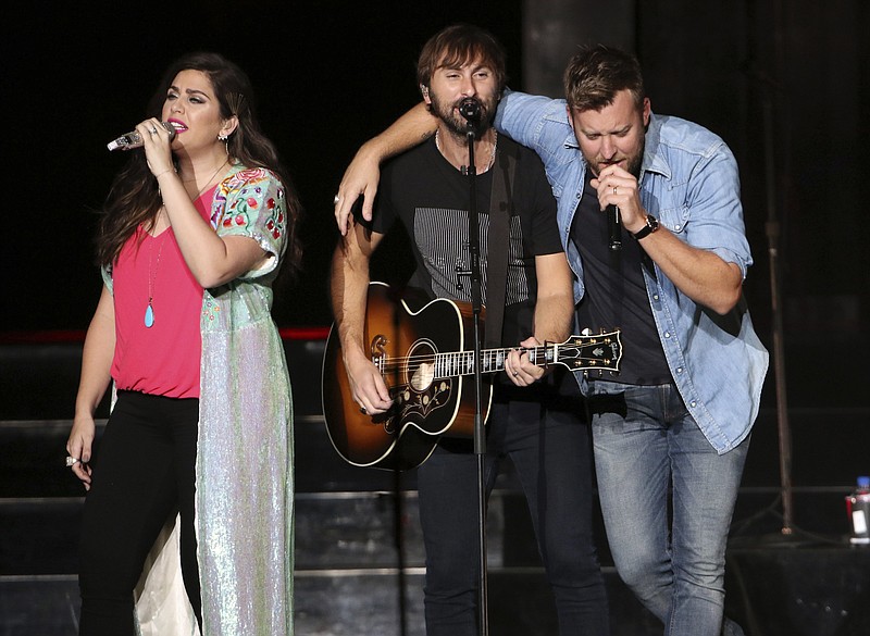 Hillary Scott, Dave Haywood and Charles Kelley with Lady Antebellum performs during the You Look Good Tour at Verizon Wireless Amphitheatre on Friday, September 8, 2017, in Atlanta. (Photo by Robb Cohen/Invision/AP)