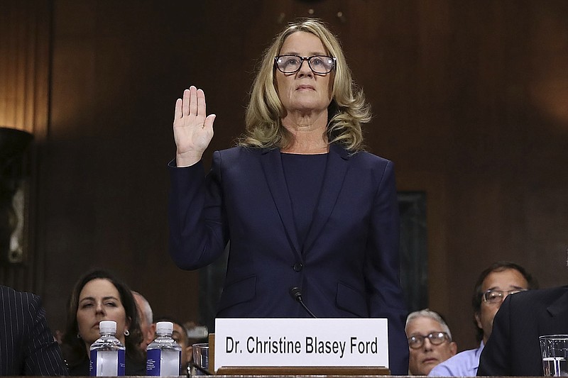 Christine Blasey Ford is sworn in before the Senate Judiciary Committee, Thursday, Sept. 27, 2018 in Washington. Her attorney's Debra Katz and Michael Bromwich watch. (Win McNamee/Pool Image via AP)