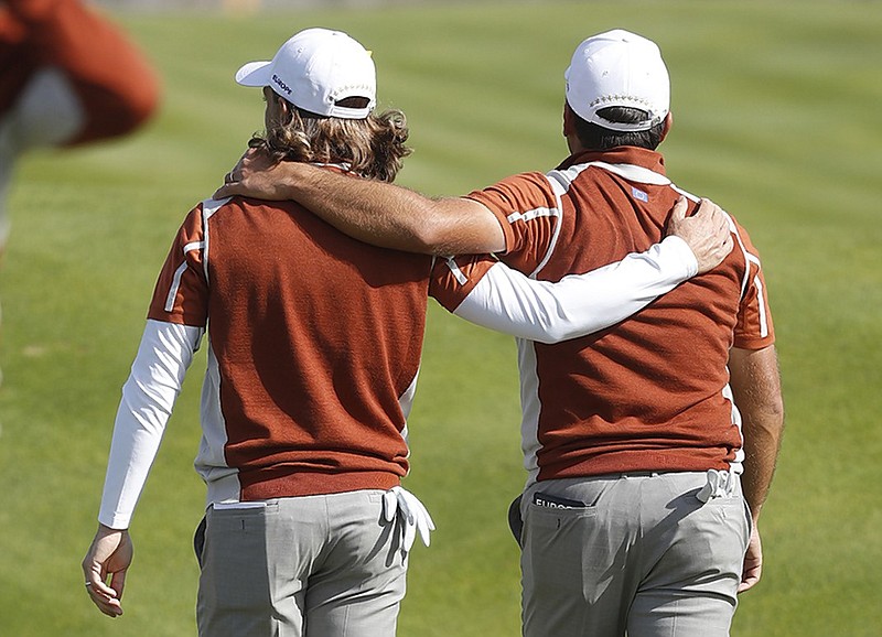 Europe's Tommy Fleetwood, left, and Francesco Molinari walk away after a fourball victory against Patrick Reed and Tiger Woods on Saturday, the second day of the Ryder Cup at Le Golf National near Paris.