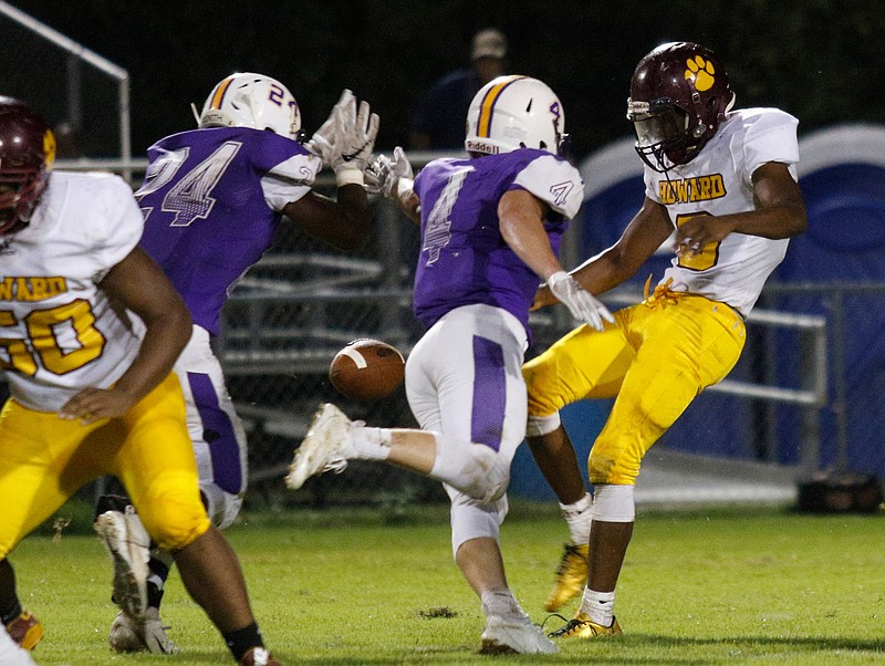 Central players DonYa Parker (24) and Hunter Jones (4) block a punt by Howard player Ellis Robinson (3) during their prep football game at Chattanooga Central High School on Friday, Sept. 28, 2018, in Chattanooga, Tenn. 