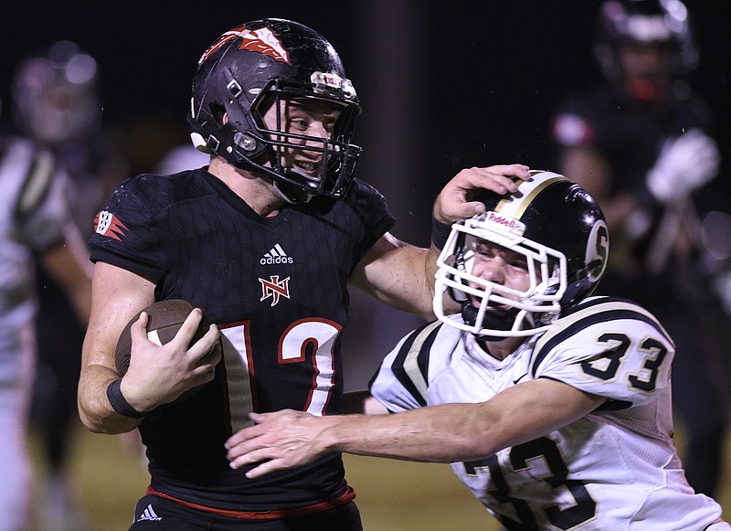 North Jackson's Tanner Woodall (12) tries to fight off the tackle of Scottsboro's Rylee Woodward  (33).  The North Jackson Chiefs hosted the Scottsboro Wildcats in a rivalry game on September 28, 2018.  