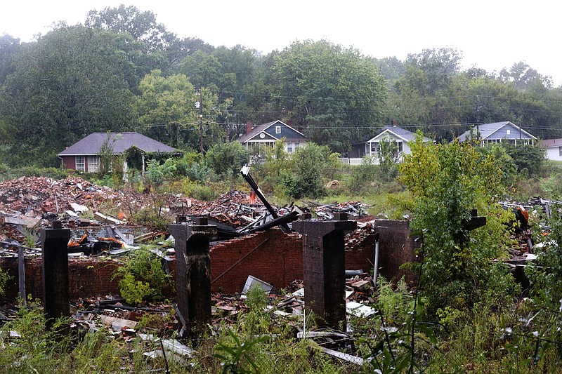 The rubble left from R.L. Stowe Mills sits in a lot in front of residences Thursday, September 27, 2018 in Lupton City, Tennessee. Residents near the old mill have complained about the pace of the promised cleanup.