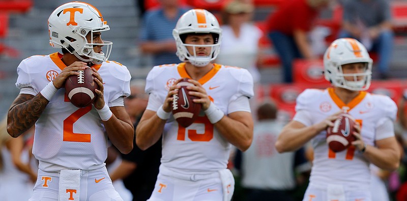 From left, Tennessee quarterbacks Jarrett Guarantano, Keller Chryst and Will McBride warm up before the Vols' Sept. 29 game at Georgia.