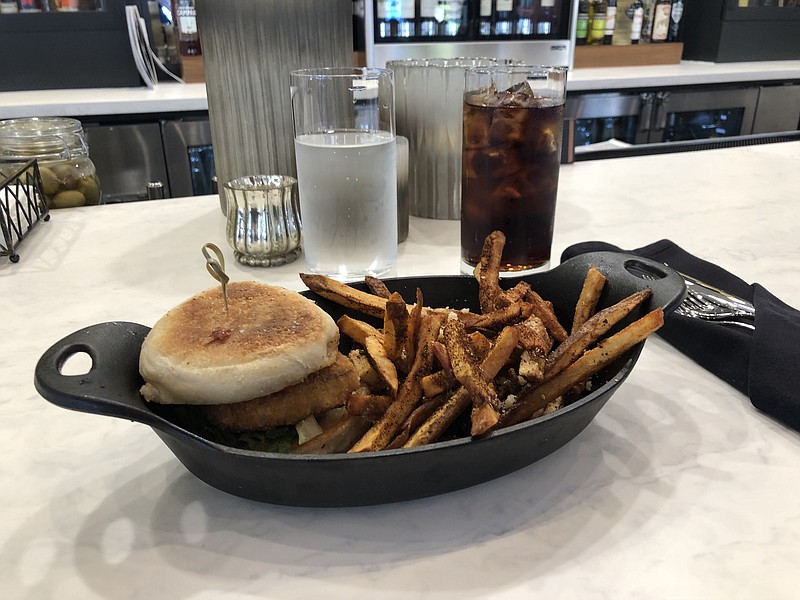 The pork chop sandwich is served in a cast-iron skillet. (Photo by Jim Tanner)