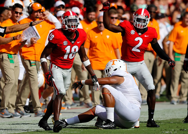 Georgia defensive backs Deandre Baker (18) and Richard LeCounte III (2) celebrate a Tennessee incomplete pass during last Saturday's 38-12 win by the Bulldogs.