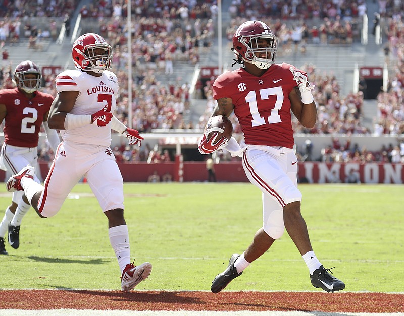 Alabama freshman receiver Jaylen Waddle finishes off his 63-yard punt return for a touchdown during last Saturday's 56-14 win over Louisiana. Crimson Tide coach Nick Saban was not happy with the half-empty student section in the background.