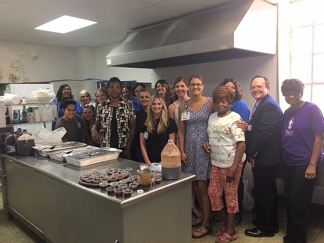 A kitchen full of love. Erlanger nurses serve barbecue provided by Tennessee Galvanizing in Marion County to celebrate a partnership with Widows Harvest Ministries.