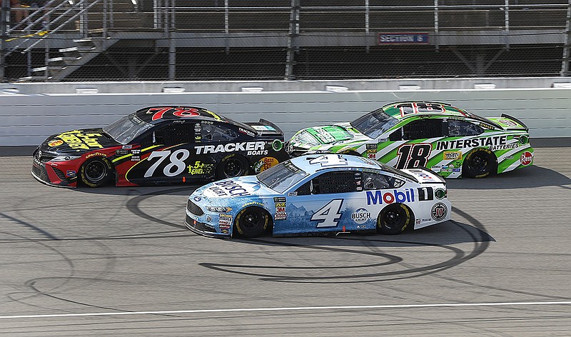 Martin Truex Jr. (78), Kevin Harvick (4) and Kyle Busch (18) battle for position during the NASCAR Cup Series race at Michigan International Speedway in August.