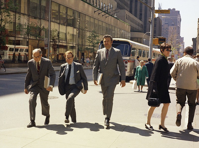 FILE - In this May 29, 1969 photo, people walk along Rockefeller Plaza area during the lunch hour in New York.   The jobless rate, the government reported Friday, Oct. 5, 2018 is at its lowest level since the 3.5 percent it reached 49 years ago. And the strength looks likely to endure. There are a record number of open jobs, consumers are confident and economic growth has been brisk. America's economic expansion is now the second-longest on record, having already surpassed the boom of the 1960s. (AP Photo)