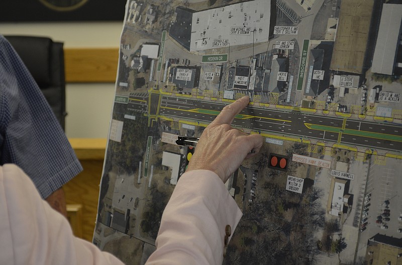 Fort Oglethorpe Councilwoman Paula Stinnett points to businesses along Lafayette Road during an August open house session about the coming improvement project. The green lines on the map indicate raised medians, many of which have been removed from the plan. (Staff photo by Myron Madden)