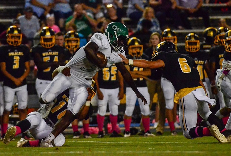 Photo by Troy Stolt / East Hamilton running back Devontay Tipton (3) is brought down in the backfield by multiple defenders during East Hamilton's game at Hixson high school on October 5, 2018.