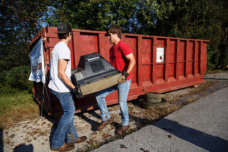 Joshua Aaroncouch, right, and Tyan Massengale load a trashed television into a dumpster near Thrasher Pike during the Tennessee River Rescue volunteer cleanup on Saturday, Oct. 6, 2018, in Soddy-Daisy, Tenn. This year marks the 30th anniversary of the region-wide cleanup which helps to maintain the Tennessee River watershed.