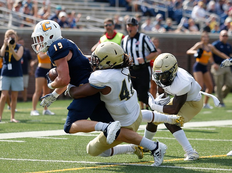 Wofford linebacker D.T. Wilson (42) tackles UTC wide receiver Bryce Nunnelly into the end zone for a touchdown during Saturday's SoCon game at Finley Stadium.