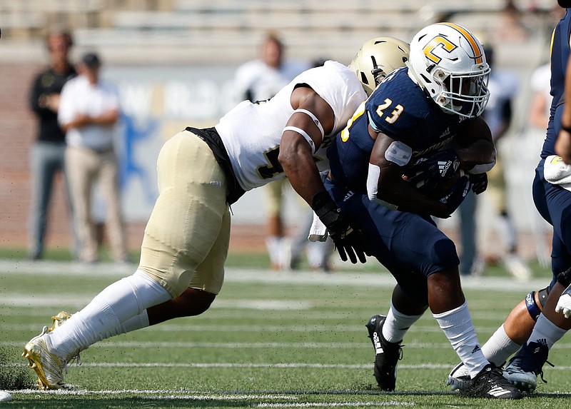 Wofford linebacker Robbie Armstrong tackles UTC running back Tyrell Price during last week's game at Finley Stadium.