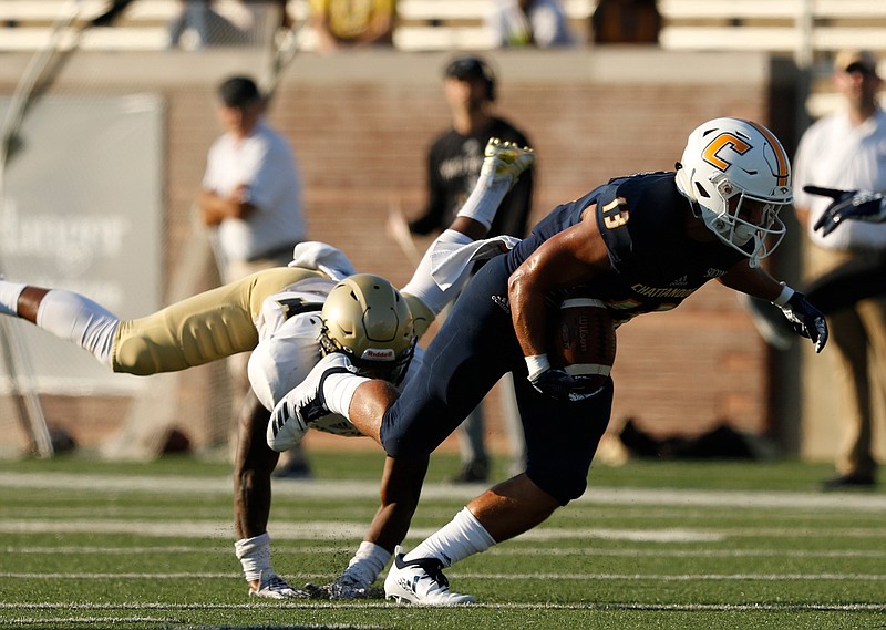UTC receiver Joseph Parker breaks a tackle by Wofford cornerback Devin Watson during their SoCon game Oct. 6 at Finley Stadium.