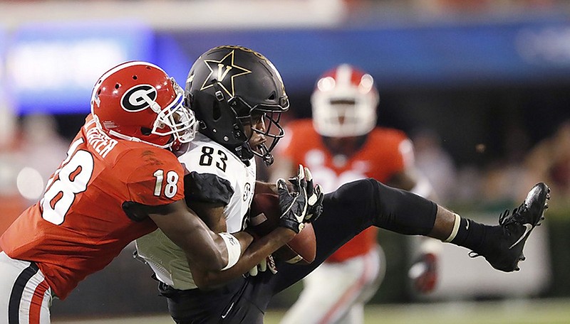 Georgia defensive back Deandre Baker, left, breaks up a pass intended for Vanderbilt wide receiver C.J. Bolar during Saturday night's game in Athens, Ga.