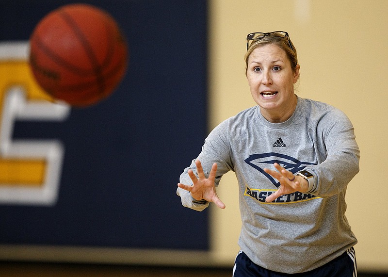 Head coach Katie Burrows goes over a drill during practice at the Chattem Basketball Practice Facility on the campus of the University of Tennessee at Chattanooga on Thursday, Sept. 27, 2018, in Chattanooga, Tenn.