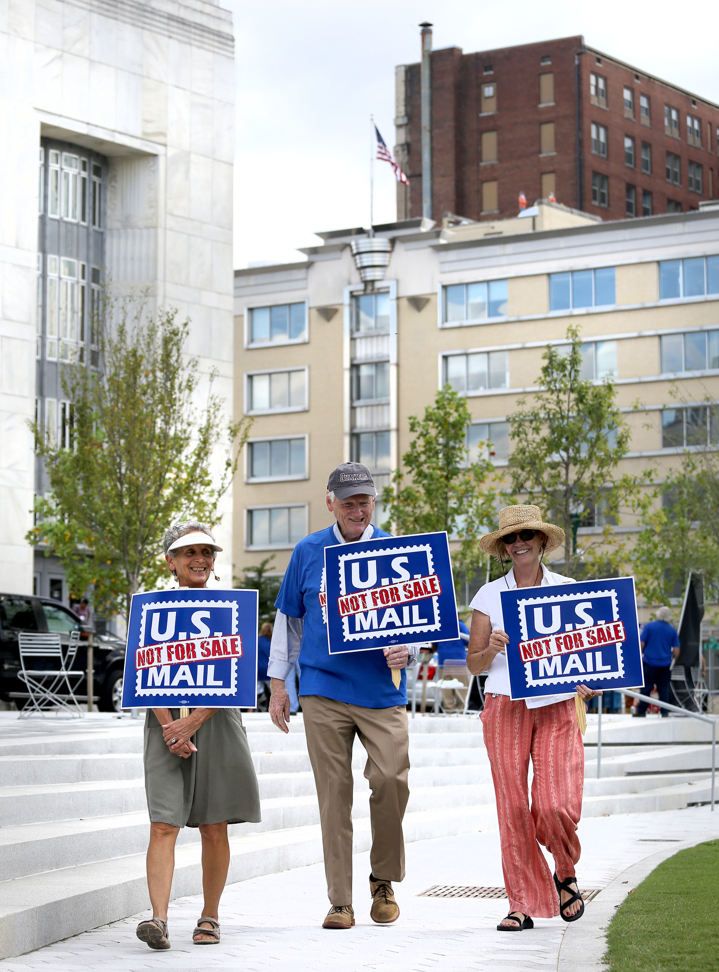 Sheila St. Aubin, Bruce Stewart and Sally Scholze walk around Miller Park with signs reading "U.S. Mail Not For Sale" Monday, October 8, 2018 in Chattanooga, Tennessee. The three are local activist that work to use their voices to create understanding and change. St. Aubin, Stewart and Scholze have stood on Market Street Bridge and in Miller Park protesting a variety of issues, including gun control, elections and more.