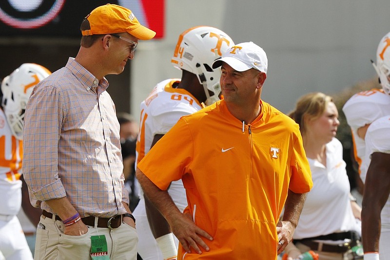 Former Tennessee quarterback Peyton Manning, left, chats with Tennessee football coach Jeremy Pruitt before the Vols' game at Georgia on Sept. 29.