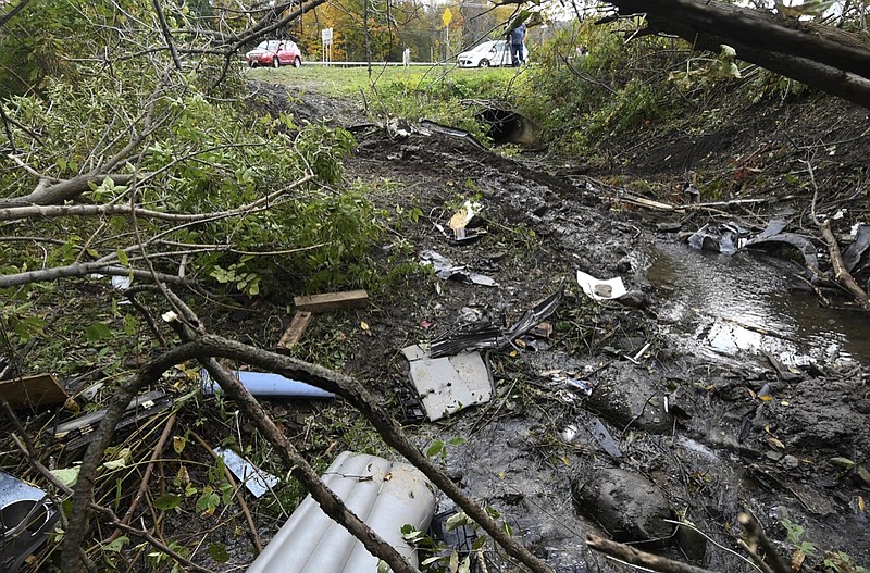 Debris scatters an area Sunday, Oct. 7, 2018, at the site of yesterday's fatal crash Schoharie, N.Y. (AP Photo/Hans Pennink)