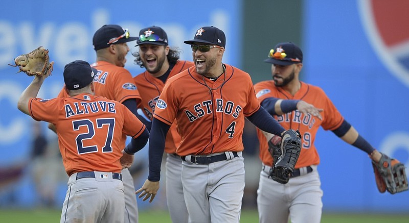 Houston Astros' George Springer (4) and teammates celebrate after defeating the Cleveland Indians in Game 3 of a baseball American League Division Series, Monday, Oct. 8, 2018, in Cleveland. (AP Photo/David Dermer)