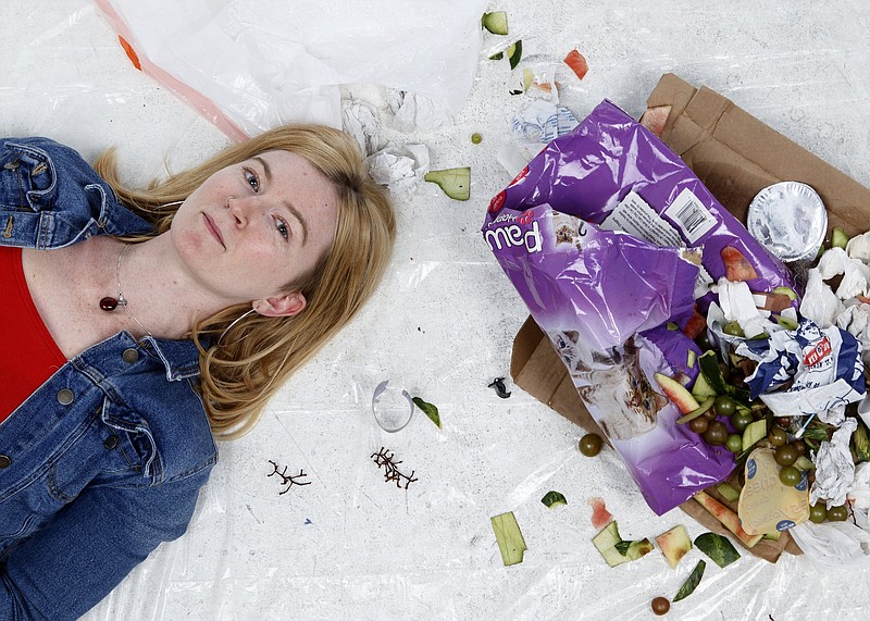 Writer Sunny Montgomery poses with 4 pounds of garbage, which, according to a 2013 EPA report, is the amount of waste generated per person every day in America.