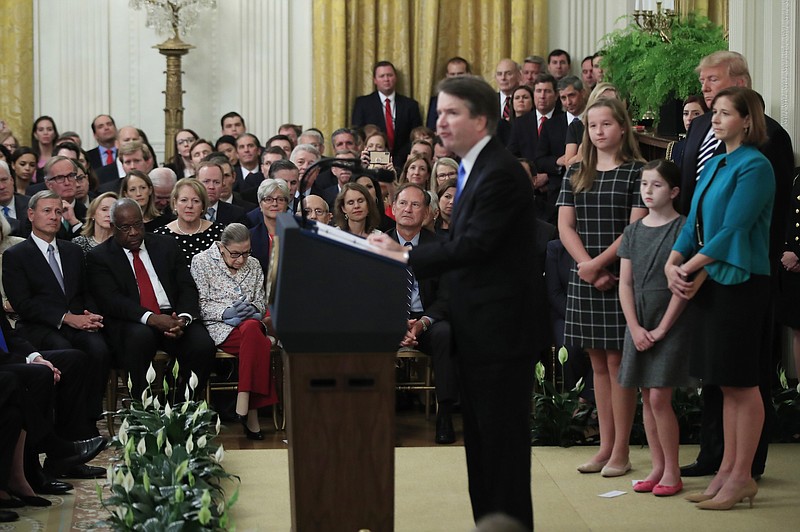 President Donald Trump, Chief Justice John Roberts, back left, and justices of the Supreme Court, listen to Justice Brett Kavanaugh speak during the ceremonial swearing-in ceremony of Kavanaugh as associate justice of the Supreme Court of the United States in the East Room of the White House in Washington on Monday. Kavanaugh is accompanied by his wife Ashley Kavanaugh, third from left, and children Margaret, second from left, and Liza. (AP Photo/Manuel Balce Ceneta)