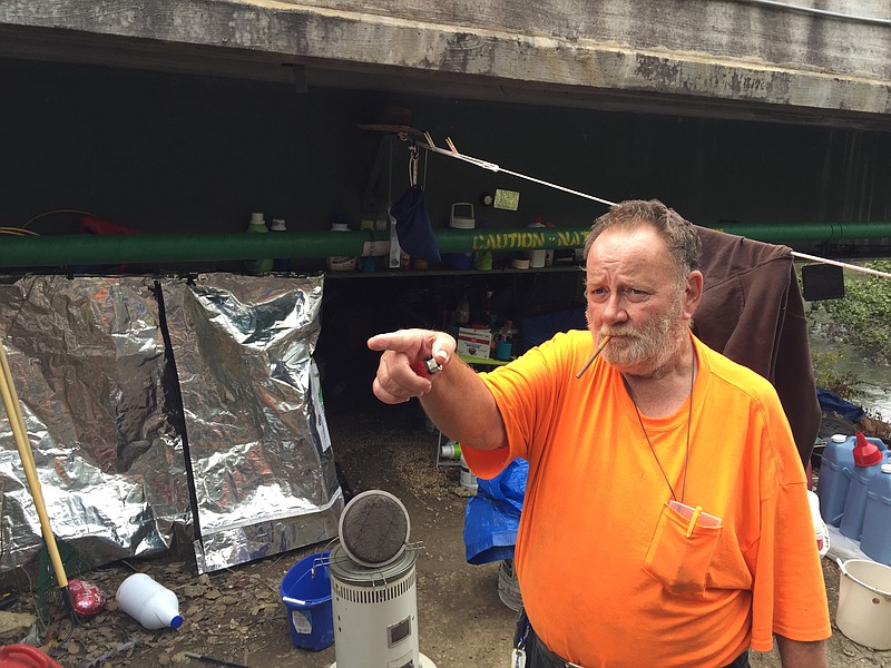 James Waters stands next to his campsite under a bridge at U.S Highway 41, above South Chickamauga Creek. Waters, a registered sex offender, said he came here on the advice of a Georgia Department of Community Supervision officer after his release from prison in July.