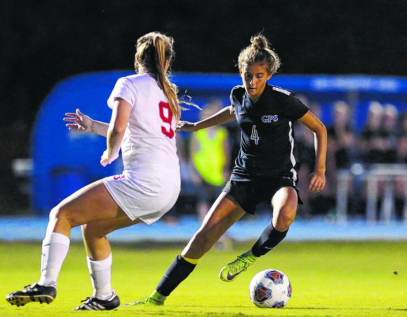 Girls Preparatory School's Kennedy Ball (4) dribbles the ball around Baylor's Ara Rhodes (9) during the Baylor vs. GPS soccer game at GPS Tuesday, October 9, 2018 in Chattanooga, Tennessee. 