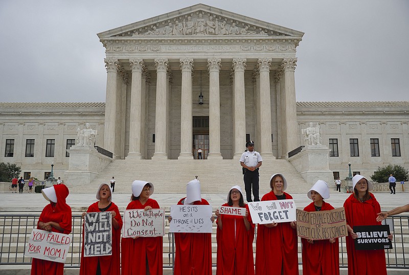 Activists protest in front of the Supreme Court in Washington on Tuesday. (AP Photo/Pablo Martinez Monsivais)