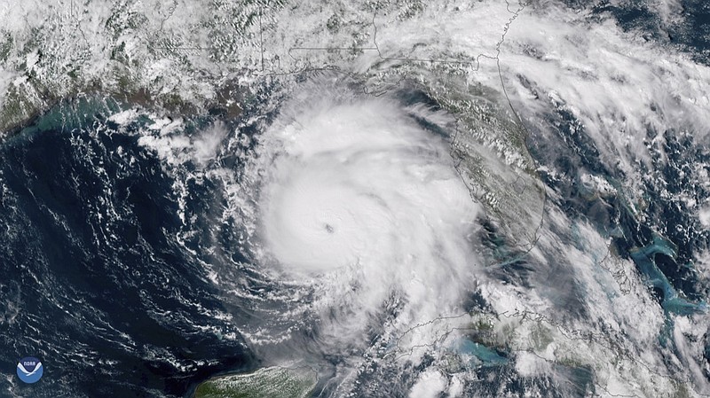 This Tuesday, Oct. 9, 2018, satellite image provided by NOAA shows Hurricane Michael, center, in the Gulf of Mexico. (NOAA via AP)