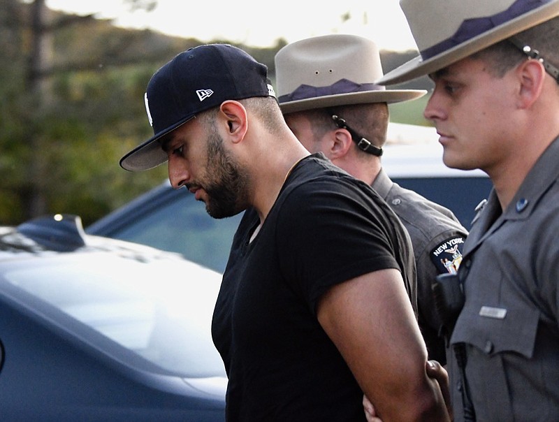 Nauman Hussain is brought into Cobleskill Town, N.Y., court for arraignment Wednesday, Oct. 10, 2018. Limousine service operator, Hussain, was charged Wednesday with criminally negligent homicide in a crash that killed 20 people, while police continued investigating what caused the wreck and whether anyone else will face charges. (AP Photo/Hans Pennink)


