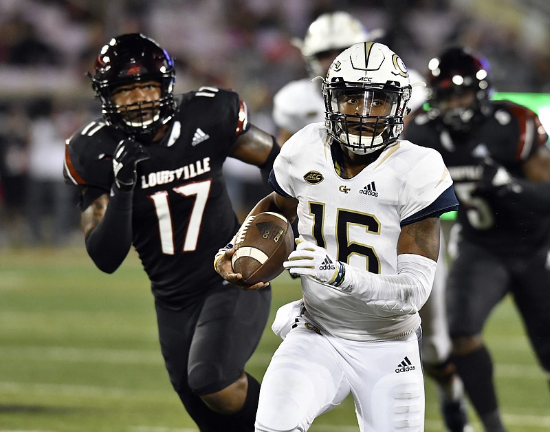 Georgia Tech quarterback TaQuon Marshall outruns Louisville linebacker Dorian Etheridge (17) during the first half of last Friday's game at Louisville. Marshall has led the Yellow Jackets to two straight lopsided wins after a 1-3 start.