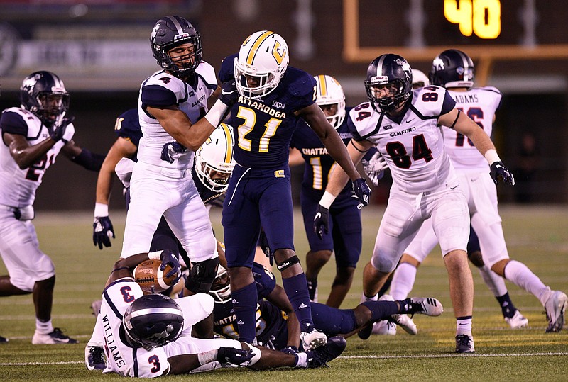 UTC safety D.J. Jackson (21) stands over Samford wide receiver Kentre'vious Williams (3) after a tackle during the Mocs' home win on Sept. 22.