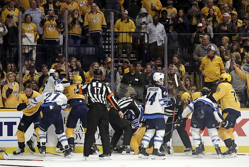 Officials try to break up several simultaneous fights during the second period of the Nashville Predators' home game against the Winnipeg Jets on Thursday. Nashville won 3-0.