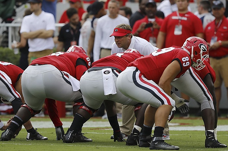 Georgia coach Kirby Smart looks over the offensive line during warmups for the Bulldogs' home game against Tennessee on Sept. 29.