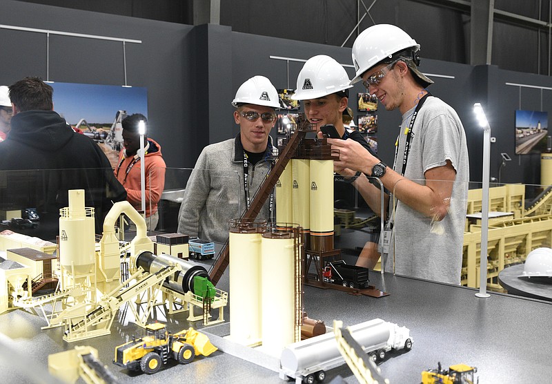 In this 2016 file photo, Ridgeland High School students Jacob Rogers, Draven Chapman and Xavier Meyer look at equipment models at Astec Inc. during a job fair. The Walker County Schools district has once again seen an increase in graduation rates thanks to factors like increased access to opportunities, state officials say.