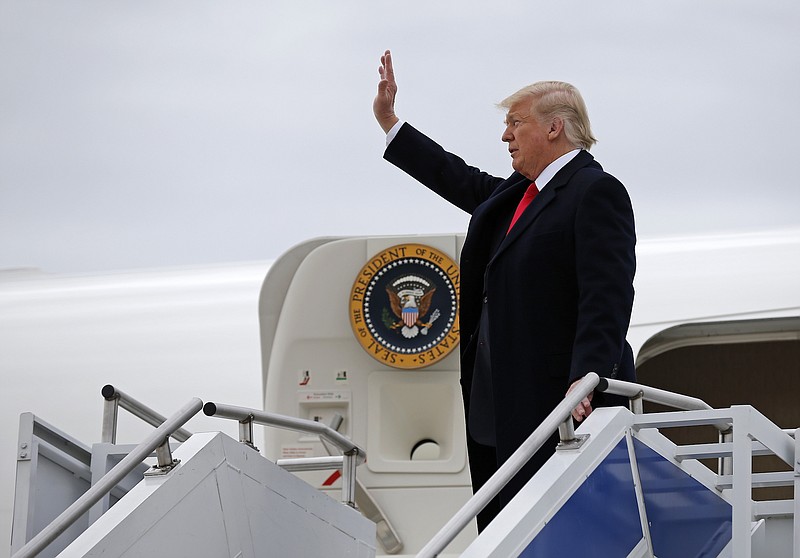 President Donald Trump waves to a gathering of supporters as he exits Air Force One after landing at Lunken Airport in Cincinnati, Ohio, on Friday.