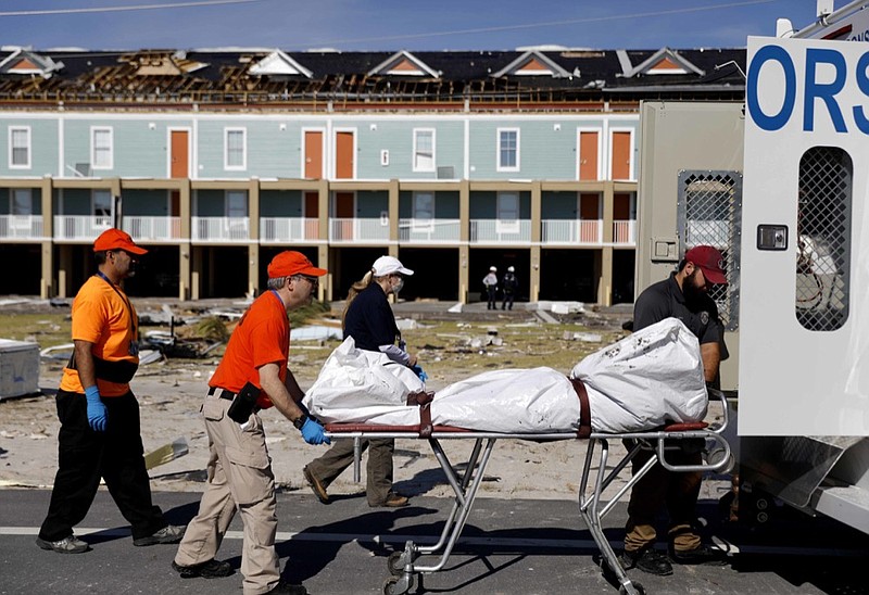 A body is removed after being discovered during the search of a housing structure in the aftermath of hurricane Michael in Mexico Beach, Fla., Friday, Oct. 12, 2018. (AP Photo/David Goldman)

