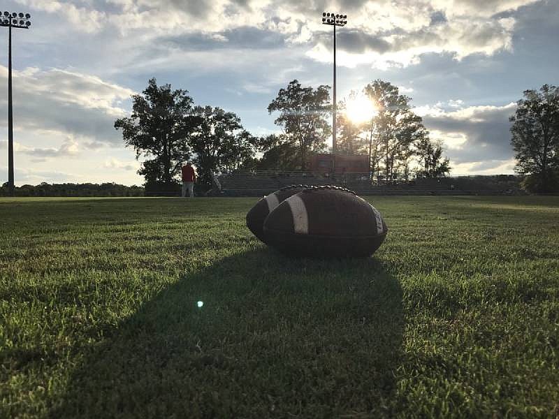 friday night football tile / The sun dips behind trees as North Jackson's RD Hicks Stadium awaits the Chief's game with Scottsboro on Friday, Sept. 28, 2018. / Staff photo by Robin Rudd
