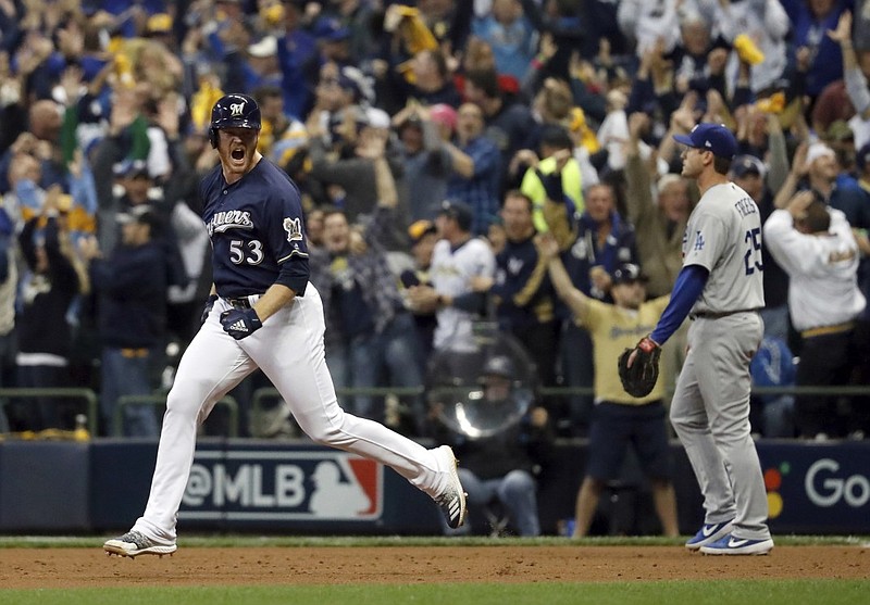 Milwaukee Brewers relief pitcher Brandon Woodruff celebrates after hitting a home run during the third inning of Game 1 of the NLCS against the Los Angeles Dodgers on Friday night at Miller Park in Milwaukee.