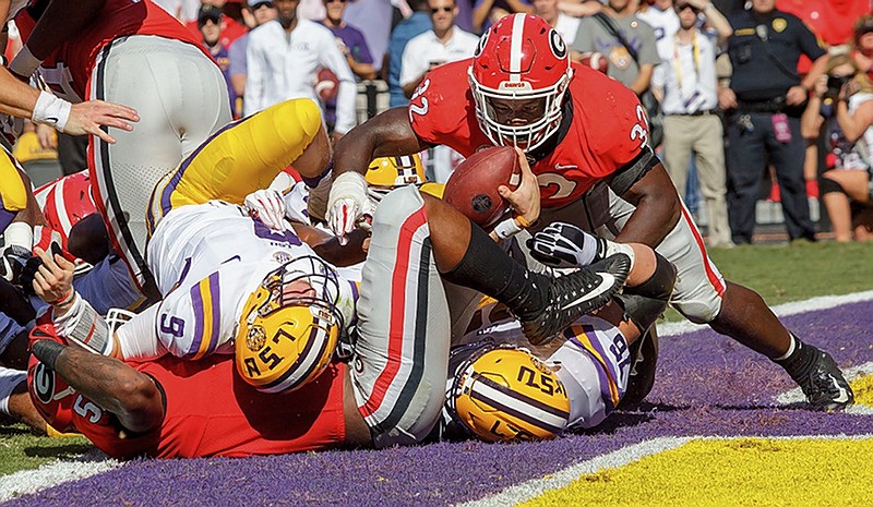 LSU quarterback Joe Burrow (9) bulls into the end zone for a first-half touchdown during the Tigers' win over second-ranked Georgia on Saturday in Baton Rouge, La.