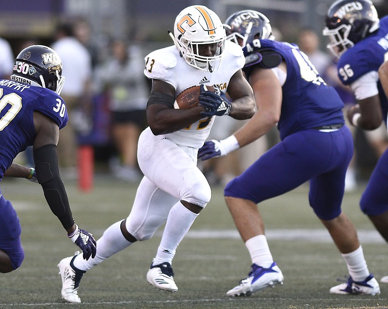 UTC's Tyrell Price gets between two Western Carolina defenders during Saturday's game in Cullowhee, N.C.