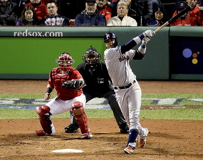 The Houston Astros' Yuli Gurriel watches his three-run home run against the Boston Red Sox during the ninth inning of Game 1 of the ALCS on Saturday night in Boston.