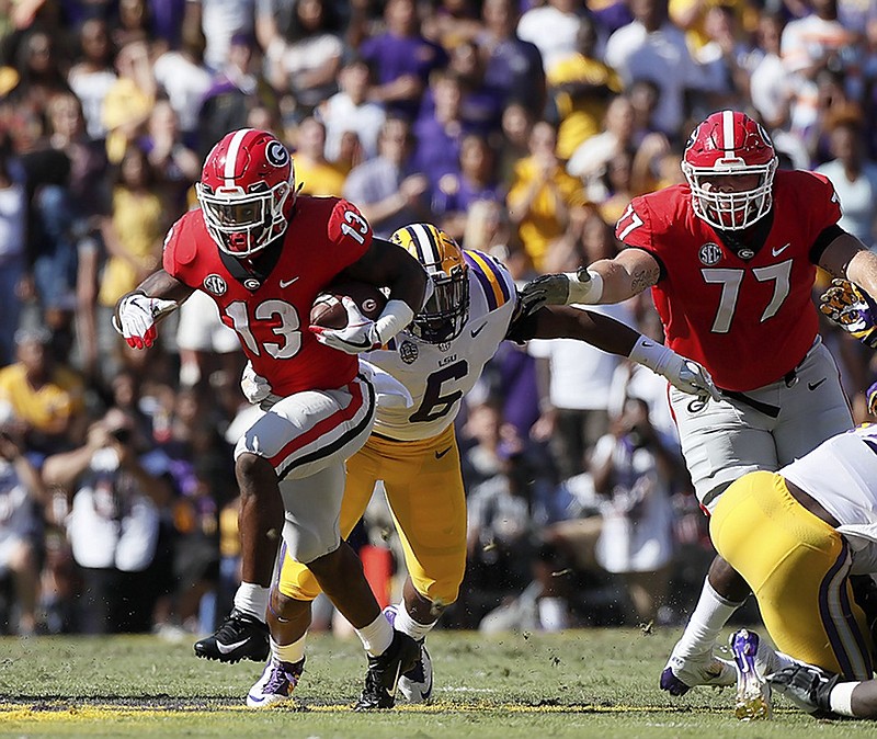 Georgia running back Elijah Holyfield weaves through the LSU defense to pick up a first down during Saturday's game in Baton Rouge, La.